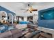 Living room with blue walls, ceiling fan, and comfortable sofas at 4538 Cortland Dr, Davenport, FL 33837