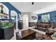 Spacious living room with blue walls, large fish tanks, and a rustic wooden coffee table at 4538 Cortland Dr, Davenport, FL 33837