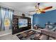 Living area with built-in entertainment center and comfortable seating at 4538 Cortland Dr, Davenport, FL 33837