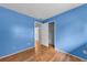 Blue bedroom with wood floors and large closet at 4689 Carmel St, Orlando, FL 32808