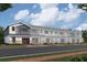 Row of townhouses with gray and blue siding, stone accents, and two-car garages at 5106 Rain Shadow Dr, Saint Cloud, FL 34772