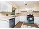 White kitchen with teal appliances and tile backsplash at 5300 Hondo Way, Orlando, FL 32810