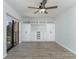 Spacious bedroom with built-in shelving and wood-look flooring at 5341 Bamboo Ct # 418, Orlando, FL 32811