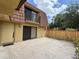 Townhouse exterior showcasing a cozy patio, neutral color scheme, and a secure fenced yard at 5341 Bamboo Ct # 418, Orlando, FL 32811