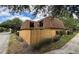 Well-maintained townhouse boasts mature trees, fenced yard, and balconies with sleek black metal railings at 5341 Bamboo Ct # 418, Orlando, FL 32811