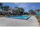 Community pool with lounge chairs and umbrellas at 5341 Bamboo Ct # 418, Orlando, FL 32811
