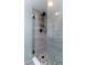 Modern shower with gray tile surround and geometric floor tile at 5341 Bamboo Ct # 418, Orlando, FL 32811