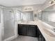 Double vanity bathroom with dark wood cabinets, tile flooring and a shower at 544 Viceroy Ct, Kissimmee, FL 34758