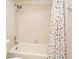 Clean bathroom with shower/tub combo, tile flooring, and a polka dot shower curtain at 669 Grenadine Ct # S, Winter Park, FL 32792