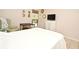 Bedroom with white bedding, a white dresser, and a view of the backyard at 669 Grenadine Ct # S, Winter Park, FL 32792