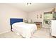 Bedroom with a blue headboard, white bedding, and a view of the backyard at 669 Grenadine Ct # S, Winter Park, FL 32792
