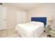 Bedroom with a blue headboard, white bedding, and tiled floor at 669 Grenadine Ct # S, Winter Park, FL 32792