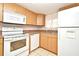 Kitchen features white appliances and light wood cabinets at 669 Grenadine Ct # S, Winter Park, FL 32792