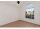 Bright bedroom featuring wood-look floors and a large window at 7921 Golden Pond Cir, Kissimmee, FL 34747