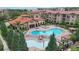 Aerial view of Bella Piazza community pool and clubhouse with surrounding buildings at 914 Charo Pkwy # 113, Davenport, FL 33897