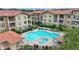 Complex featuring a large pool, spa, and multiple buildings at 914 Charo Pkwy # 113, Davenport, FL 33897