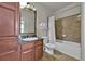Bathroom with tub shower combination, vanity, and linen cabinet at 914 Charo Pkwy # 113, Davenport, FL 33897