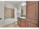 Bathroom with tub shower combination, vanity, and linen cabinet at 914 Charo Pkwy # 113, Davenport, FL 33897