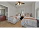 Bedroom with two twin beds, ceiling fan, and adjacent bathroom at 914 Charo Pkwy # 113, Davenport, FL 33897