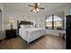Spacious bedroom with king-size bed, large window, and wood-look floors at 914 Charo Pkwy # 113, Davenport, FL 33897