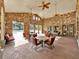 Community room with stone walls, comfortable seating, and pool views at 914 Charo Pkwy # 113, Davenport, FL 33897