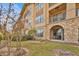 Building exterior showcasing a stone facade and private patio at 914 Charo Pkwy # 113, Davenport, FL 33897