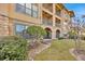Building exterior with landscaping and multiple balconies at 914 Charo Pkwy # 113, Davenport, FL 33897