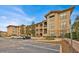 Tan colored building exterior with parking and landscaping at 914 Charo Pkwy # 113, Davenport, FL 33897