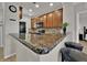 Modern kitchen with granite countertops and wood cabinets at 914 Charo Pkwy # 113, Davenport, FL 33897