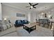 Bright living room with couches, coffee table, and large windows at 914 Charo Pkwy # 113, Davenport, FL 33897