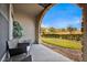Relaxing patio with seating area and view of landscaped grounds at 914 Charo Pkwy # 113, Davenport, FL 33897