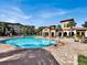 Community pool with lounge chairs and a relaxing atmosphere at 914 Charo Pkwy # 113, Davenport, FL 33897