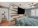 Bright bedroom with wood-paneled accent wall and large TV at 1 Black Jack Cir, Port Orange, FL 32128