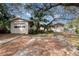 Home's exterior features a detached garage and grassy yard at 1 Black Jack Cir, Port Orange, FL 32128