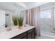 Bathroom with double vanity, marble tile, and shower/tub combo at 1060 Leader St, Davenport, FL 33896