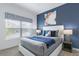 Bedroom with a white bed frame and blue accents at 1060 Leader St, Davenport, FL 33896