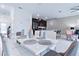 Open concept dining area with white table and chairs, view of kitchen and living room at 1060 Leader St, Davenport, FL 33896