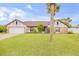 Single-story home with a stone facade and a palm tree in the front yard at 110 Dianne Dr, Ormond Beach, FL 32176