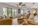 Living room with wicker furniture and large windows at 110 Dianne Dr, Ormond Beach, FL 32176