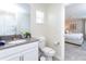 Bathroom with toilet, vanity, and view of bedroom at 1176 Challenge Dr, Davenport, FL 33896