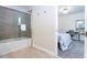 Bathroom with tub and shower combination, and view into bedroom at 1176 Challenge Dr, Davenport, FL 33896