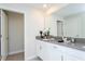 Bathroom with double sinks, grey countertops, and a large mirror at 1176 Challenge Dr, Davenport, FL 33896