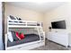 Bedroom featuring bunk beds, dresser, and wall-mounted TV at 1176 Challenge Dr, Davenport, FL 33896