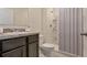 Bathroom with dark vanity, toilet, and shower with curtain at 1177 Alstonia Ln, Mount Dora, FL 32757