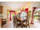 Bright dining room with wooden table and red curtains at 12002 Great Commission Way, Orlando, FL 32832