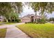 House exterior with landscaping and driveway at 12002 Great Commission Way, Orlando, FL 32832