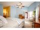 Main bedroom with light blue walls, a king-size bed, and access to the backyard at 12002 Great Commission Way, Orlando, FL 32832