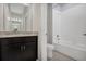 Bathroom with dark vanity, granite countertop, and white bathtub at 1232 White Ash Loop, Deland, FL 32720