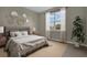 Bedroom with gray bedding, neutral wall decor, and large window at 1232 White Ash Loop, Deland, FL 32720