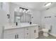 Updated bathroom with double sinks, white cabinets, and marble tile at 124 Mercado Ave, Orlando, FL 32807